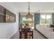 Cozy dining area with unique light fixture, rustic table, and sliding glass doors to outdoor space at 17971 W Meadowbrook Ave, Goodyear, AZ 85395