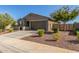 Charming single-story home featuring a desert-landscaped front yard and a two-car garage at 17971 W Meadowbrook Ave, Goodyear, AZ 85395