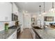 Modern kitchen with granite counters, stainless appliances, and center island at 17971 W Meadowbrook Ave, Goodyear, AZ 85395