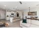 Open-concept kitchen with an island, pendant lighting, modern appliances, and a view into the living area at 17971 W Meadowbrook Ave, Goodyear, AZ 85395