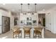 Bright kitchen features a large island with pendant lights and stainless steel appliances at 17971 W Meadowbrook Ave, Goodyear, AZ 85395