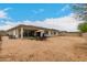 Large backyard featuring a covered patio and ample space for outdoor activities and entertaining at 18134 W Highland Ave, Goodyear, AZ 85395