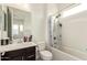 Bright bathroom with a tub and shower, a dark vanity, and recessed lighting at 18134 W Highland Ave, Goodyear, AZ 85395