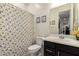 Cheerful bathroom with sunflower-themed curtain, modern fixtures, and bright natural light at 18134 W Highland Ave, Goodyear, AZ 85395