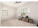 Spacious bedroom with plush carpet, a ceiling fan, and plenty of natural light from large windows at 18134 W Highland Ave, Goodyear, AZ 85395