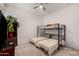 Cozy bedroom featuring a full over full bunk bed and TV on a dark wood stand at 18134 W Highland Ave, Goodyear, AZ 85395