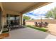 Covered patio extends into an outdoor dining and seating area in a spacious backyard at 18134 W Highland Ave, Goodyear, AZ 85395