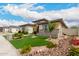 Stunning single-story home with desert landscaping, synthetic lawn, and stone accents at 18134 W Highland Ave, Goodyear, AZ 85395