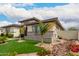 Stunning single-story home with desert landscaping, synthetic lawn, and stone accents at 18134 W Highland Ave, Goodyear, AZ 85395