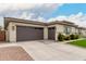 Spacious two-car garage with ample driveway space and modern design elements at 18134 W Highland Ave, Goodyear, AZ 85395