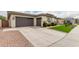 Spacious two-car garage with ample driveway space and modern design elements at 18134 W Highland Ave, Goodyear, AZ 85395