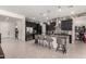 Open kitchen with a large island, pendant lighting, dark cabinets, and decorative backsplash at 18134 W Highland Ave, Goodyear, AZ 85395
