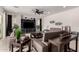 Bright living room showcasing a large TV, modern decor, and comfortable leather seating at 18134 W Highland Ave, Goodyear, AZ 85395