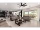 Spacious living room features a modern ceiling fan, sliding doors, and adjoins the open concept kitchen at 18134 W Highland Ave, Goodyear, AZ 85395
