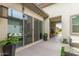 Spacious patio featuring sleek sliding glass doors and outdoor plant at 18134 W Highland Ave, Goodyear, AZ 85395