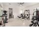 Workout room includes tile floors and space for both cardio and weight training equipment at 18134 W Highland Ave, Goodyear, AZ 85395