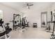 Bright workout room featuring a ceiling fan, tile floors and plenty of space for fitness equipment at 18134 W Highland Ave, Goodyear, AZ 85395