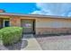 Inviting front entrance with brick accents, manicured bushes, and a well-lit walkway at 18610 N Mica Dr, Sun City West, AZ 85375