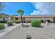 Well-maintained single story home with xeriscaping, complemented by tidy hedges, a palm tree, and a sidewalk at 18610 N Mica Dr, Sun City West, AZ 85375