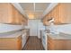 Bright kitchen with wooden cabinets, granite-style countertops, and wood flooring provides ample space and modern amenities at 18610 N Mica Dr, Sun City West, AZ 85375