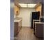 Galley kitchen featuring wood cabinets, granite countertops and stainless-steel appliances at 18610 N Mica Dr, Sun City West, AZ 85375