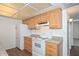 Functional kitchen featuring wooden cabinetry, white appliances, and granite-look countertops for a stylish and practical cooking space at 18610 N Mica Dr, Sun City West, AZ 85375