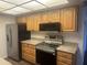 Bright kitchen with wooden cabinets, granite countertops and stainless-steel appliances at 18610 N Mica Dr, Sun City West, AZ 85375