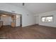 Spacious living room with wood look tile floors, open to the kitchen, and lots of natural light at 18610 N Mica Dr, Sun City West, AZ 85375