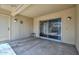 Covered back patio with sliding glass door, light fixture and outdoor space perfect for relaxing or entertaining at 18610 N Mica Dr, Sun City West, AZ 85375
