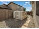 Backyard shed providing extra storage; the desert landscape ensures low maintenance with an attractive walkway at 19203 S 185Th Dr, Queen Creek, AZ 85142