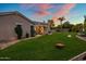 Wide view of backyard featuring covered patio, landscaping and lush lawn with seating areas at 19203 S 185Th Dr, Queen Creek, AZ 85142