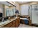 Well-appointed bathroom featuring double sinks, granite counters, a soaking tub, and a glass-enclosed shower at 19203 S 185Th Dr, Queen Creek, AZ 85142