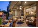 Inviting covered patio with comfortable seating, ceiling fan, and view of the lush backyard at 19203 S 185Th Dr, Queen Creek, AZ 85142