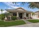 Inviting single-story home with manicured lawn, covered porch, and stone accents at 19203 S 185Th Dr, Queen Creek, AZ 85142