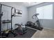 Home gym with fitness equipment, a stationary bike, weights, and plenty of natural light at 19203 S 185Th Dr, Queen Creek, AZ 85142