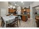 Spacious kitchen featuring wooden cabinetry, granite countertops, and a center island with an adjacent dining area at 19203 S 185Th Dr, Queen Creek, AZ 85142