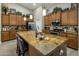 Spacious kitchen island with wine, cheese, granite countertops, and stainless steel appliances at 19203 S 185Th Dr, Queen Creek, AZ 85142