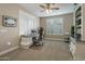 Bright office with plantation shutters, built-in cabinets, and neutral carpet at 19203 S 185Th Dr, Queen Creek, AZ 85142