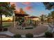 Community playground area, perfect for families, with slides, climbing structures, and shaded seating at 19203 S 185Th Dr, Queen Creek, AZ 85142