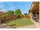 Green backyard with a well-kept lawn and a secure wood fence, perfect for outdoor activities at 1933 E Lafayette Ave, Gilbert, AZ 85298