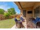 Charming backyard featuring a cozy covered patio with stylish furniture and a well-manicured lawn at 1933 E Lafayette Ave, Gilbert, AZ 85298