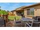 Expansive backyard with lush grass, a covered patio, and outdoor seating for entertaining guests at 1933 E Lafayette Ave, Gilbert, AZ 85298