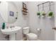 Bathroom with a round mirror, toilet and a hanging plant decoration on the wall at 1933 E Lafayette Ave, Gilbert, AZ 85298