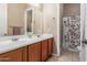 Bathroom featuring a dual sink vanity with tile flooring, and a separate shower at 1933 E Lafayette Ave, Gilbert, AZ 85298