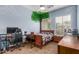 Bedroom with a bed, gaming desk, painted tree mural on the wall and ceiling fan at 1933 E Lafayette Ave, Gilbert, AZ 85298