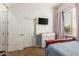 Bedroom with a bed, window, ceiling fan, closet, and television at 1933 E Lafayette Ave, Gilbert, AZ 85298