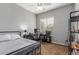 Bedroom with a bed, ceiling fan, window, desk and black metal shelving unit at 1933 E Lafayette Ave, Gilbert, AZ 85298
