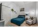 Bedroom with a bed, chair, and decor on shelves on the wall at 1933 E Lafayette Ave, Gilbert, AZ 85298