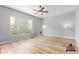 Bright and airy bedroom with ample natural light and wood-look flooring, staged virtually at 1933 E Lafayette Ave, Gilbert, AZ 85298