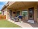 Relaxing covered patio with comfortable seating, string lights, and a convenient access door at 1933 E Lafayette Ave, Gilbert, AZ 85298